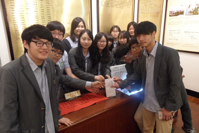 상하이 대한민국임시정부에 기부금을 전달하고 있는 동아리 학생들